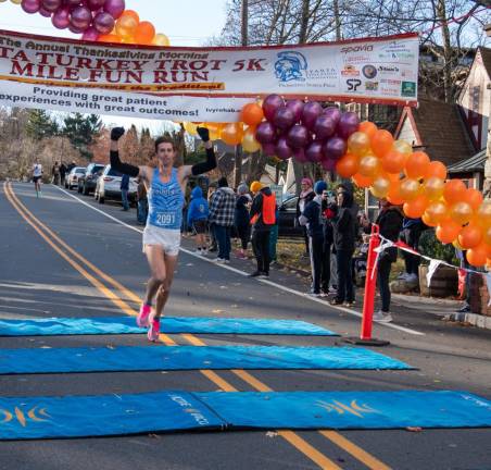 Jason Gibbons crosses the finish line first.