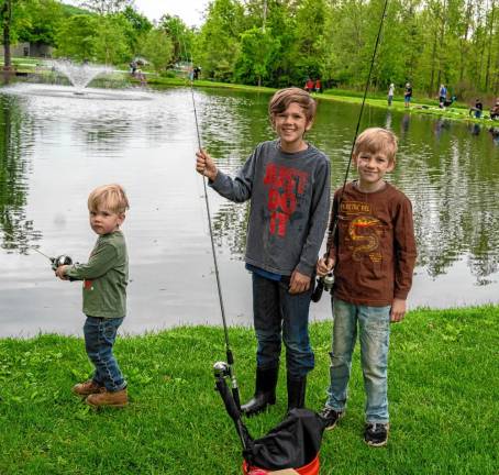 Brave, Coles and Maverick Muehleisen pose with their fishing poles.