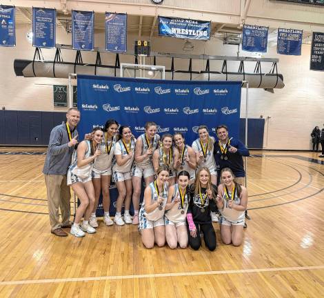 SGB2 Members and coaches of the Sparta High School girls basketball team show off their medals for winning the Hunterdon/Warren/Sussex Tournament. (Photo by Aidan Mastandrea)