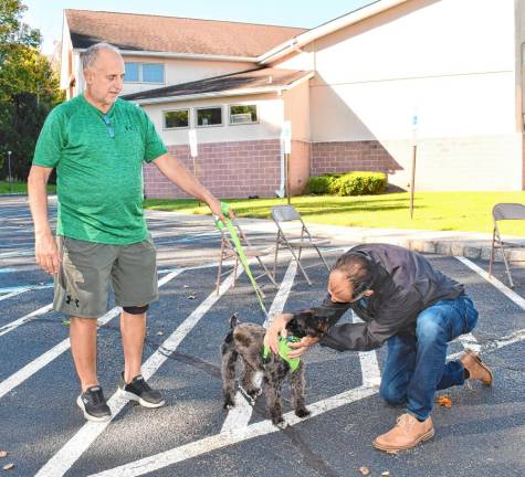 The Rev. Dr. Jack DiMatteo blesses a dog named Shadow. (Photo by Maria Kovic)