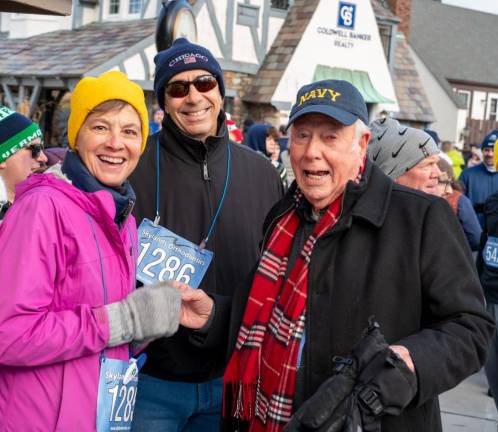 Catherine and Rob Roy pose with Bob Nicholson, 95, before all three took part in the Turkey Trot.