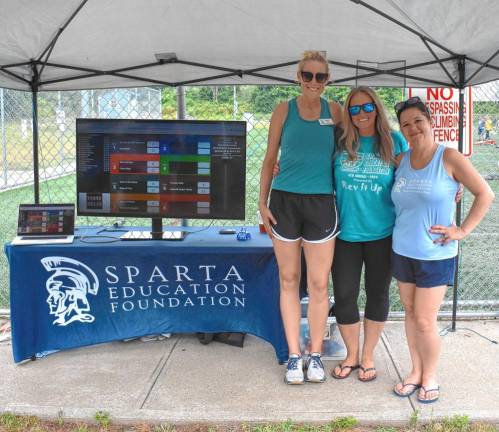 Event co-chairwomen Meghan Jent, left, and Pamela Miller, right, with the Cornament founder Heather Egli.