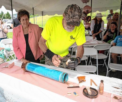 Marjorie Strohsahl, a co-founder of the Sparta Historical Society, watches Ron Constable remove items from a time capsule at a party to celebrate her 80th birthday. The time capsule had materials from a Girl Scout troop who camped at Camp Sacajawea in 1969. (Photos by Nancy Madacsi)