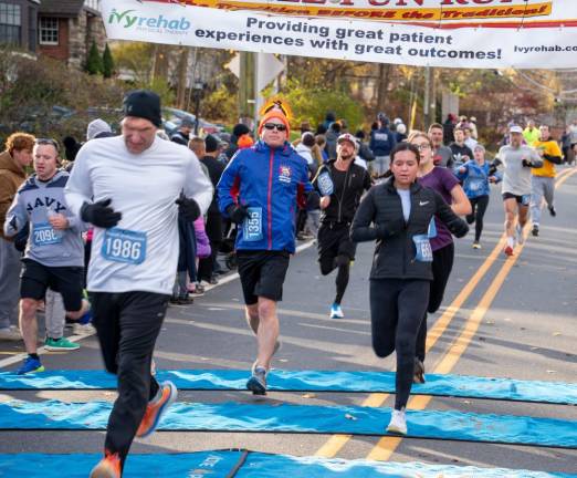 5K runners cross the finish line. The USATF-certified course started and ended at Krogh’s Restaurant &amp; Brew Pub.