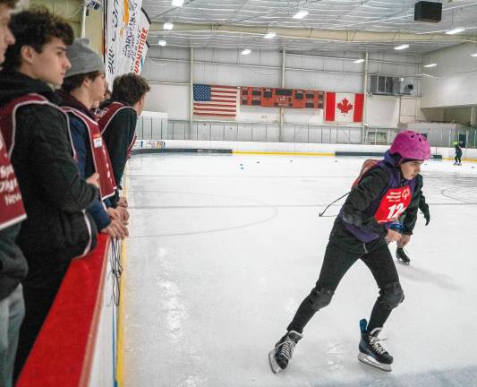 <b>Volunteers watch Kristina Pkhrikyan skate. (Photo by Nancy Madacsi)</b>