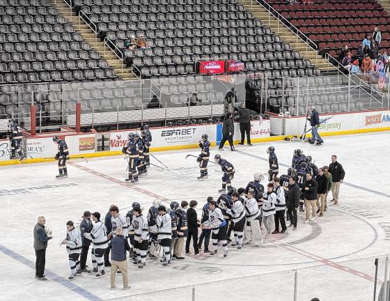 KJ3 The players congratulate those on the other team at the end of the game.