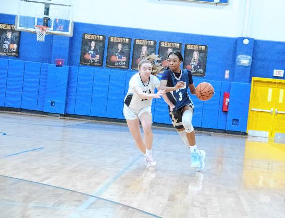 Pope John's Mia Washington drives forward as Immaculate Heart's Casey McCauley tries to keep pace. Washington scored 22 points in the game.