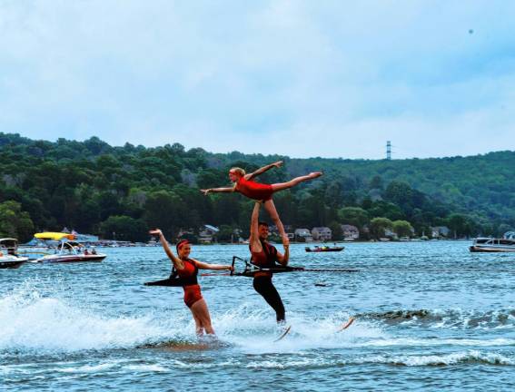 Kate Sutphen, left, is on her swivel ski as Carter Higgins performs a straps lift with Saige Lieb during the Ski Hawks’ first show of the season on Lake Mohawk.