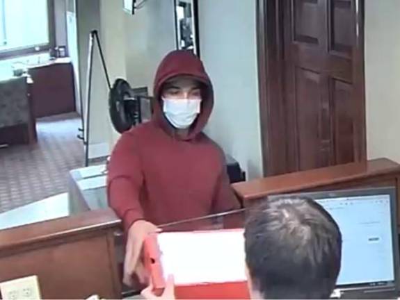 The robbery suspect was wearing a red hooded sweatshirt and a blue surgical-style face mask.