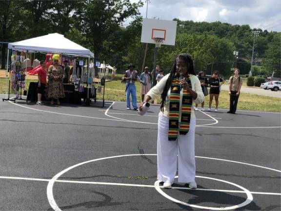 The Rev. Shea Maultsby of Unity of Sussex County in Lafayette pours liquid on the ground as a libation to Mother Earth.