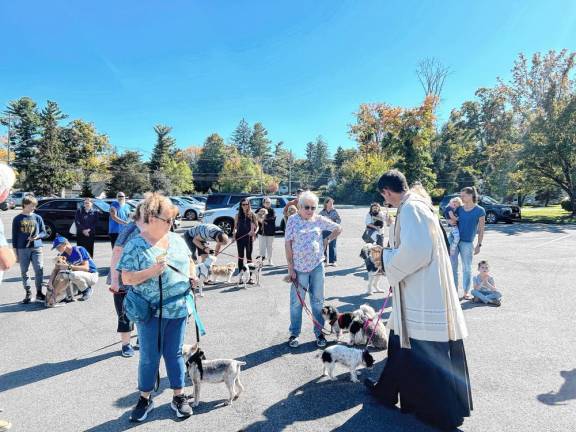 The Rev. A. Richard Carton blesses animals Sunday, Oct. 6 at Our Lady of the Lake Church in Sparta. More than 40 animals received a blessing as well as a treat courtesy of Waggmore, Maxwell and Molly, and Sparta Pet Shoppe &amp; Spa. (Photo provided)