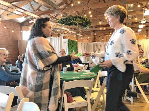 <b>Dawnice LaFebre, right, , treasurer of the German Christmas Market of New Jersey, presents a check to Valerie Macchio, executive director of the Sparta Community Food Pantry.</b>