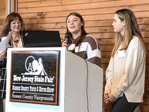 <b>Magdalen Costello, center, describes the work of the nonprofit Weekend Bag Program that she runs with her sister Olivia, right.</b>