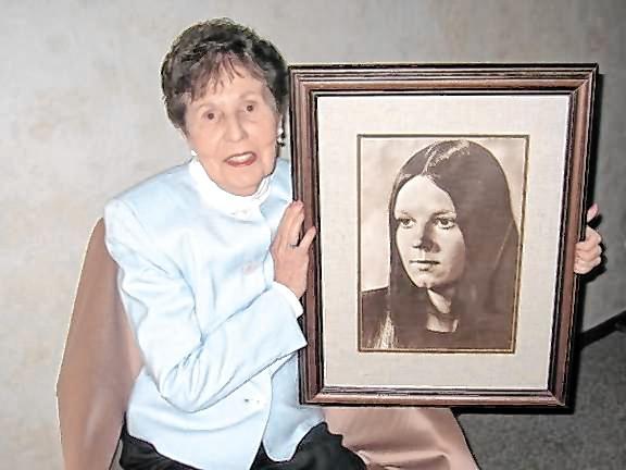 Julia Quinlan with a portrait of her daughter Karen Ann. (File photo provided)