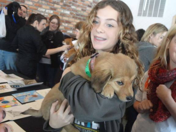 Photos by Scott Baker Regan Thiel, 13, of Andover, gets to know O.S.C.A.R. rescue Charlie.