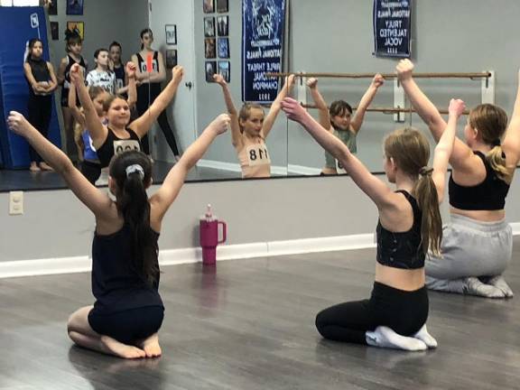 Girls ages 8-12 perform in front of a mirror during the auditions.