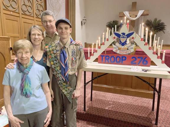 Connor McQuillan stands with his grandmother and parents at his Eagle Court of Honor. They, along with his grandfather, are scouters who supported Connor on his trail to Eagle.