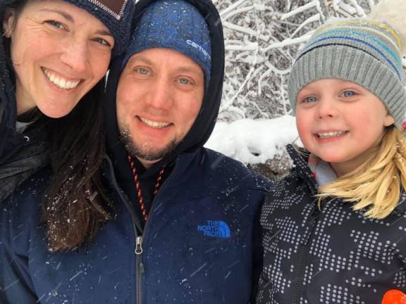 The Fedlich family took a moment to check out the snow, while their littlest one napped inside.