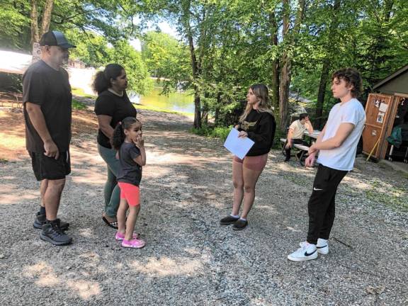 Counselors Mia and Michael Harrison, right, give Cesar and Kenia Gomez and their daughter Kacey, 5, a tour of the Bubbling Springs Day Camp in West Milford.