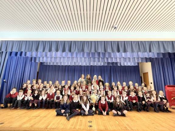 Students at Reverend George A. Brown Memorial School in Sparta pose with the first-place Stuff the Stocking trophy.