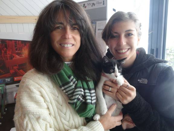 Yvette and Sirena Adessa, of Sparta, get to know Deetle the kitten.