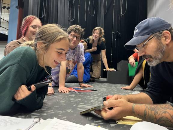 Bryan Wieczezak, right, of Sparta, head carpenter of an Emmy Award-winning televisiom show, guides construction students on how to build set pieces for ‘She Kills Monsters.’