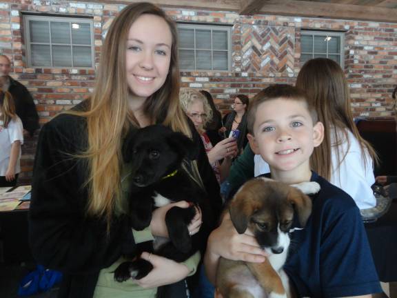 Alex Flockhart, 9, and Shaye Daly, 15, both of Sparta, spend some time with O.S.C.A.R. rescues Christian and Tippy.