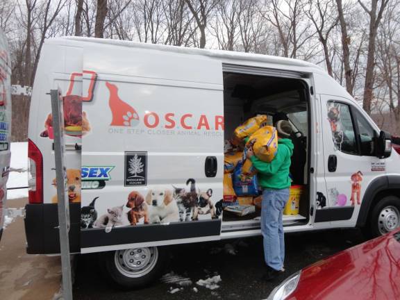 Photos by Scott Baker Lou Verile Jr. of Montague, volunteers to help load the O.S.C.A.R. van with newly-donated supplies.