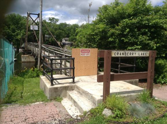 The NJDEP ordered closure of the Cranberry Lake footbridge in a letter to Cranberry Lake Community Club president Mary Seage on June 5. The notice cites an engineering report and a previous request to limit foot traffic to four or fewer people. (Photo by Mandy Coriston)