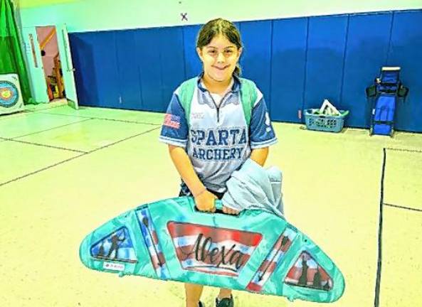 Alexa Mayben, a fourth-grader at Helen Morgan School, wiuth her archery equipment.