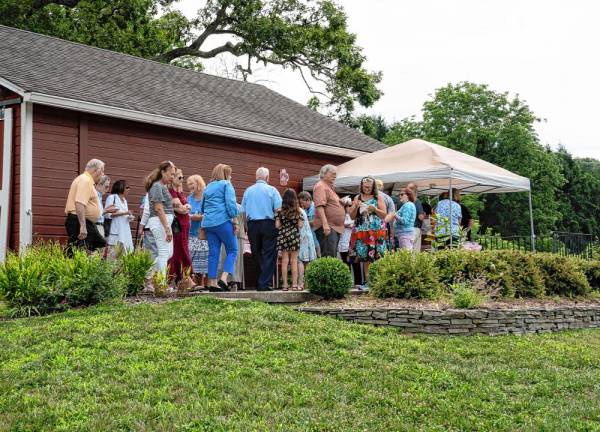 More than 100 people attended the party on the Van Kirk Homestead Museum patio.