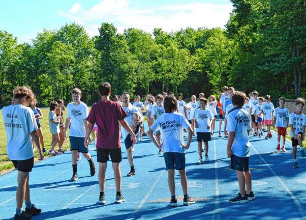 Campers stretch before beginning practice.