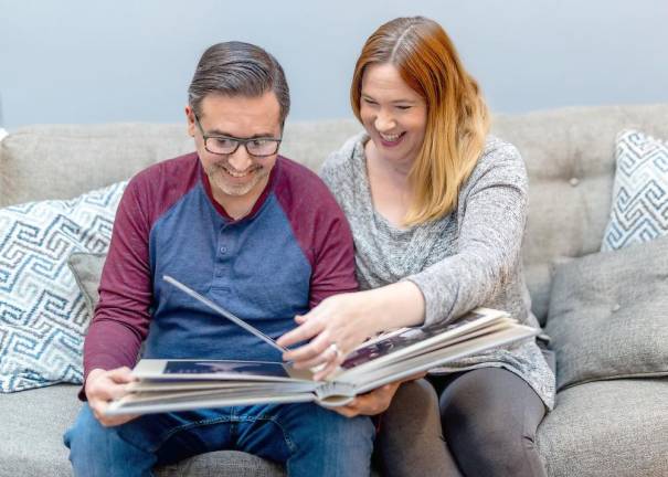 Jose and Alyssandra Ludica of Sparta look at their wedding photos.