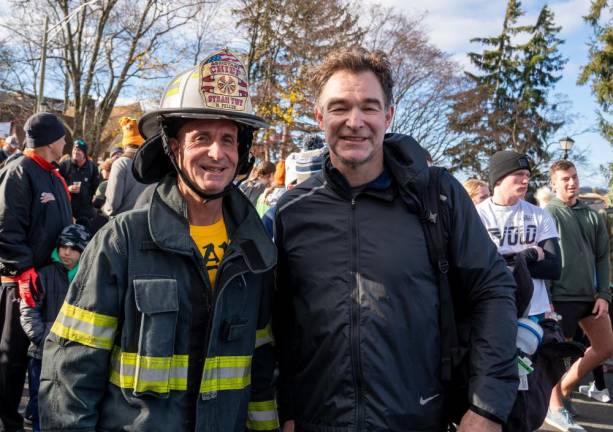 Mike Tellek ran the 5K in his full firefighting gear. At right is James O’Bosky.