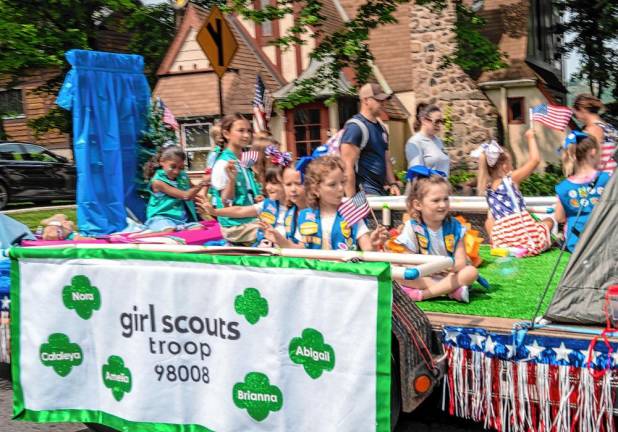 Members of Girl Scouts Troop 98008 ride in the parade.