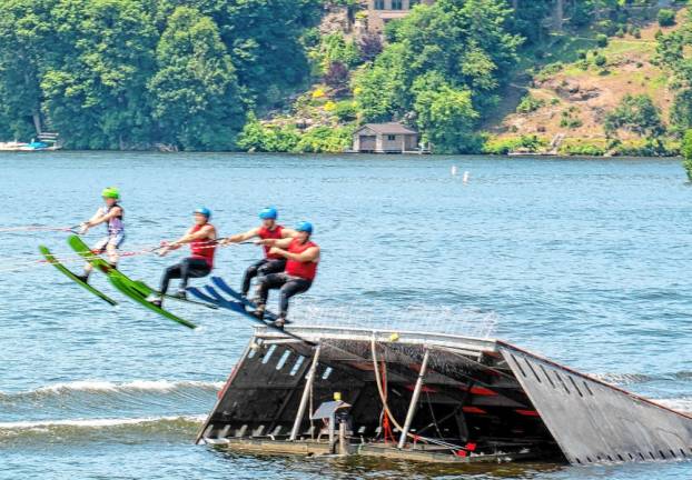 Grant Lieb, Tom Askin, Chris Andres and Damon Jenkins perform a four-man ride over the ski jump.