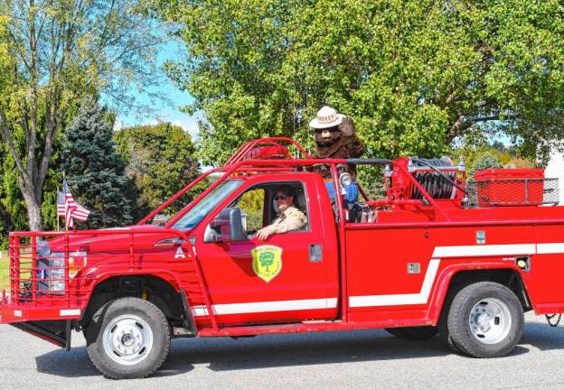 Smokey the Bear rides in the parade. He is celebrating his 80th birthday this year.