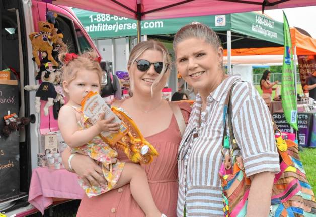 Elizabeth Franco of Hawthorne holds her daughter Ashley. Ellen Barbara of Hamburg is at right.