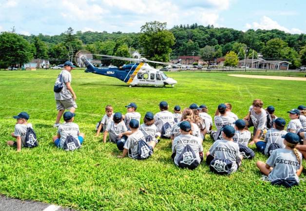 Junior Police Academy participants learn about the NorthSTAR helicopter, which provides emergency medical services.