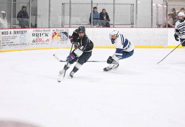 KJS United's Eddy Brown steers the puck. He scored one goal in the game against Chatham.