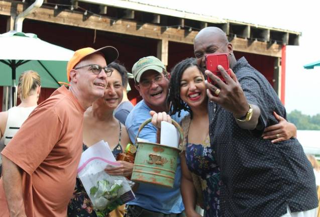 In a garden party selfie, Patrick Moynihan (center) shows off his award for Most Hospitable garden.