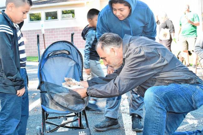 The Rev. Dr. Jack DiMatteo of Shepherd of the Hills Lutheran Church in Sparta blesses a rabbit named Lucky on Saturday, Oct. 5. (Photo by Maria Kovic)