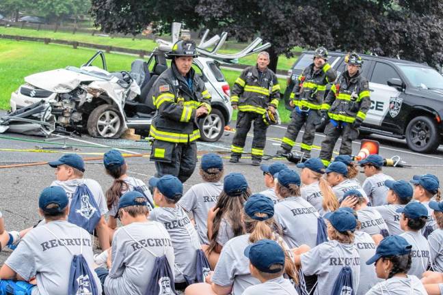 After a demonstration, firefighters talk about how they dismantle a car after a crash.