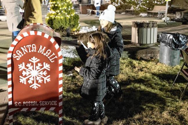 Children mail letters to Santa.