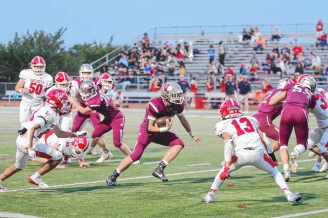 <b>Newton running back Nick Kurilko moves through an opening in the Lenape Valley defense in the first half.</b>