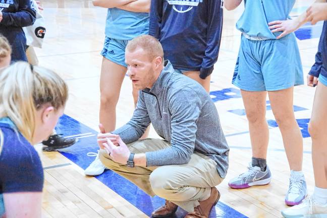 Sparta girls basketball head coach Patrick McCarney speaks to players during a break.