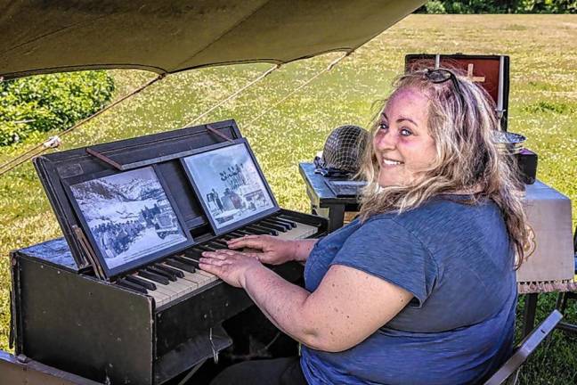 Sparta resident Lynn Crandall plays a pump organ in the World War II chaplain’s tent.