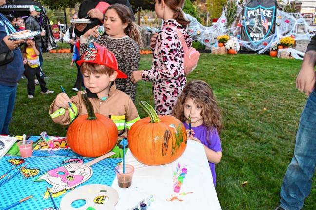 Maison and Ali Mazza paint pumpkins at the Hanging with Heroes event.