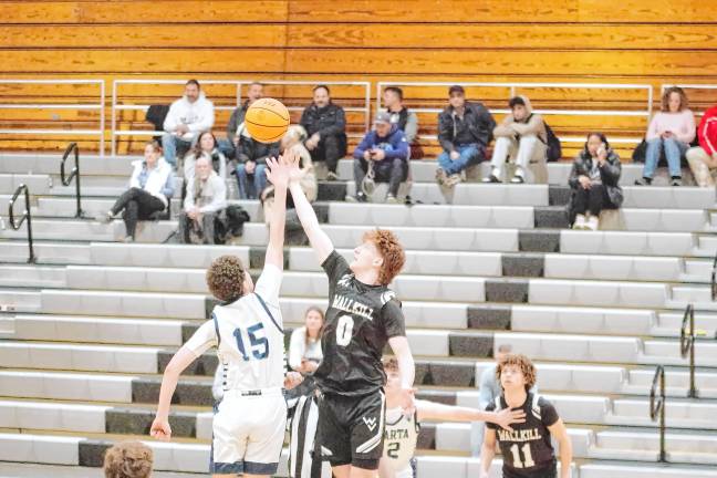 A Spartan and a Ranger reach for the ball during the tip-off to start the game.