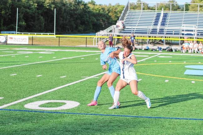 Sparta's Mya Grycuk, left, and Chatham's Ava Paone jostle while trying to get positioned beneath the ball. The Spartans won, 2-1, in overtime Sept. 16. (Photos by George Leroy Hunter)